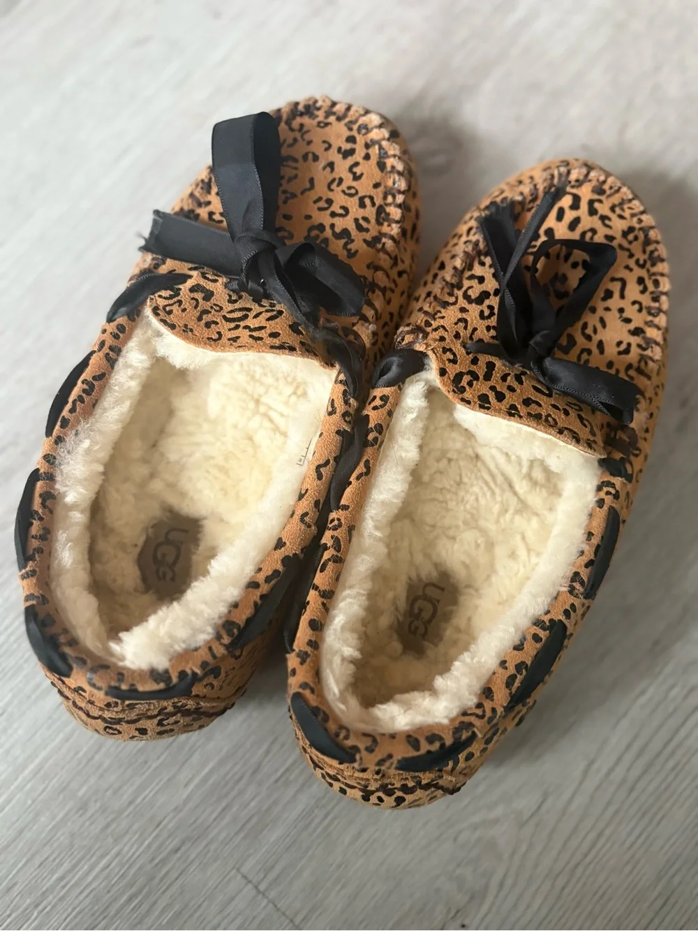 UGG women’s Leopard Print Faux-Fur Lined Slip-Ons in Brown and Black